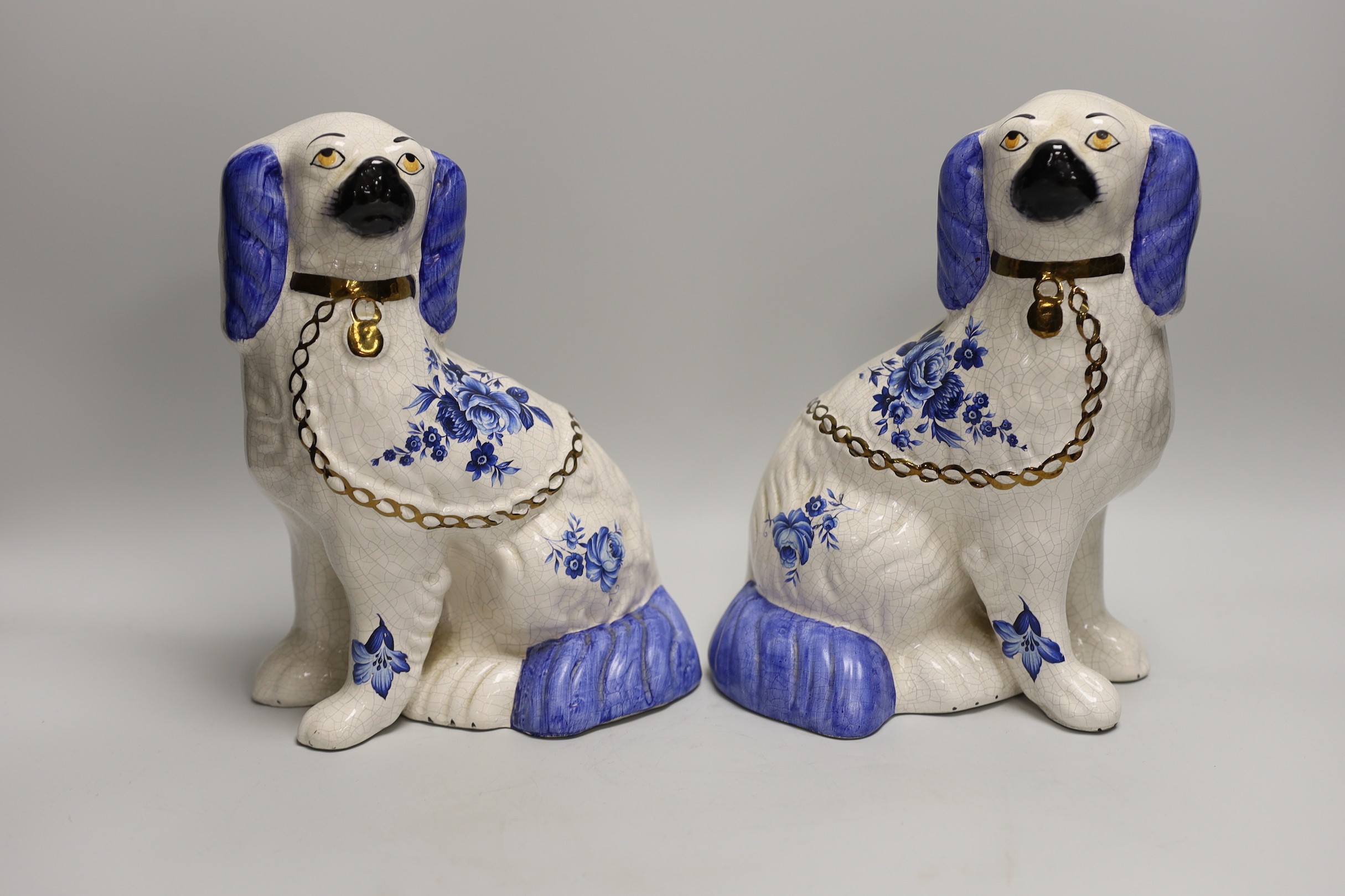 A pair of Staffordshire style comforter spaniels and two other items